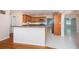 Open kitchen design with wood cabinetry, stainless steel appliances, and a breakfast bar overlooking the living area at 2736 45Th N Way, St Petersburg, FL 33713