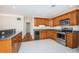 Well-lit kitchen with wood cabinets, stainless steel appliances, and tiled flooring at 2736 45Th N Way, St Petersburg, FL 33713