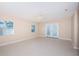 Bright living room with tiled floors, ceiling fan, and access to the backyard through French doors at 2736 45Th N Way, St Petersburg, FL 33713