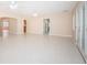 Open floor plan living room with tiled floor, French doors, and arched entryways for a spacious feel at 2736 45Th N Way, St Petersburg, FL 33713