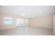 Bright living room with tile floors, ceiling fans, windows and access to the backyard at 2736 45Th N Way, St Petersburg, FL 33713