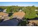 Aerial view of building exterior with a three-car garage and large second-story screened in porch at 2934 Lichen Ln # D, Clearwater, FL 33760