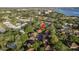Aerial view of a home surrounded by lush trees and located near a beautiful blue water source at 2934 Lichen Ln # D, Clearwater, FL 33760