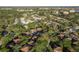 High aerial of a dense residential community with mature tree cover and nearby waterfront at 2934 Lichen Ln # D, Clearwater, FL 33760
