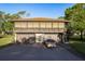 Building exterior with a three-car garage and large second-story screened in porch at 2934 Lichen Ln # D, Clearwater, FL 33760