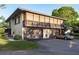 Two-story home with a balcony and three garage spaces, with a gold convertible parked in the driveway at 2934 Lichen Ln # D, Clearwater, FL 33760