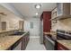 Kitchen featuring granite counters, stainless steel appliances and view into living room at 2934 Lichen Ln # D, Clearwater, FL 33760