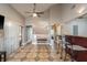Open-concept living room with tiled floors, bar seating, and an entrance to an adjacent bedroom at 2934 Lichen Ln # D, Clearwater, FL 33760