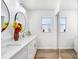Bright bathroom featuring double vanity, updated fixtures, and wood look flooring at 303 Cranston Pl, Sun City Center, FL 33573