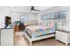 Cozy bedroom featuring desk, bed, and a ceiling fan at 303 Cranston Pl, Sun City Center, FL 33573