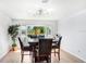 Dining room with a view, wood-look flooring, and modern light fixture at 303 Cranston Pl, Sun City Center, FL 33573