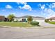 Attractive home featuring lush landscaping, blue accents, and a spacious driveway in a well-maintained neighborhood at 303 Cranston Pl, Sun City Center, FL 33573