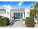 Charming home entrance with bright blue doors, modern lighting and manicured landscaping under a blue sky at 303 Cranston Pl, Sun City Center, FL 33573