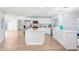 Spacious renovated kitchen with stainless steel appliances and a large island at 303 Cranston Pl, Sun City Center, FL 33573