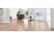 Bright living room with wood-look flooring and a view of the dining area and front door at 303 Cranston Pl, Sun City Center, FL 33573