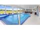 Enclosed lanai featuring an indoor pool with water feature at 303 Cranston Pl, Sun City Center, FL 33573