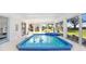 Enclosed lanai featuring an indoor pool and jacuzzi at 303 Cranston Pl, Sun City Center, FL 33573