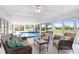 Enclosed lanai featuring an indoor pool and seating area at 303 Cranston Pl, Sun City Center, FL 33573