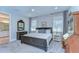 Well-lit main bedroom featuring a dark wood bed, carpet, and an ensuite bathroom at 3200 Long Spur, Odessa, FL 33556