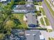 This aerial view shows a nice backyard, a large pool and a brick paved driveway on a well maintained street at 3310 W Swann Ave, Tampa, FL 33609