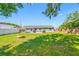 Spacious backyard offering lush green grass, mature trees, and ample room for outdoor activities and relaxation at 3310 W Swann Ave, Tampa, FL 33609