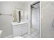 Bright bathroom with white vanity, mirror, and tiled shower/tub at 3310 W Swann Ave, Tampa, FL 33609