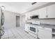 Functional kitchen featuring white cabinets and modern appliances at 3310 W Swann Ave, Tampa, FL 33609