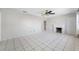 Bright living room with tile flooring, ceiling fan, and a decorative fireplace at 3310 W Swann Ave, Tampa, FL 33609