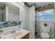 Bathroom with sea-themed wallpaper, wood shelves, a window, and a toilet at 39142 Kendell Dr, Zephyrhills, FL 33542