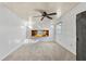 Cozy bedroom featuring carpeted floors, a ceiling fan, and a built-in display shelf at 39142 Kendell Dr, Zephyrhills, FL 33542