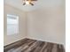 Cozy bedroom with a ceiling fan and dark wood-look flooring and window at 405 Laguna Mill Dr, Ruskin, FL 33570