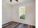 Bedroom with a large arched window offering natural light and hardwood style floors at 405 Laguna Mill Dr, Ruskin, FL 33570