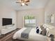Nicely staged bedroom with sliding glass doors leading to an outdoor patio at 405 Laguna Mill Dr, Ruskin, FL 33570