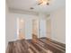 Bedroom featuring stylish laminate flooring and bathroom and closet entrances at 405 Laguna Mill Dr, Ruskin, FL 33570