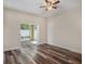 Bedroom with stylish laminate flooring and sliding glass doors to outdoor patio at 405 Laguna Mill Dr, Ruskin, FL 33570