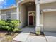 The front door is red and is covered by a portico at 405 Laguna Mill Dr, Ruskin, FL 33570