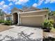 Inviting front exterior features a two-car garage and a walkway to the front door at 405 Laguna Mill Dr, Ruskin, FL 33570