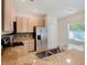 Bright kitchen featuring stainless steel appliances, granite countertops, and tiled backsplash at 405 Laguna Mill Dr, Ruskin, FL 33570
