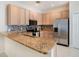Kitchen features granite counters, stainless steel appliances and eat-up breakfast bar at 405 Laguna Mill Dr, Ruskin, FL 33570