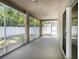 Spacious screened patio with neutral walls, overlooking the fenced backyard at 405 Laguna Mill Dr, Ruskin, FL 33570