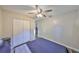 Bedroom featuring a ceiling fan, hardwood flooring, and double-door closet at 4703 Serena Dr, Tampa, FL 33617