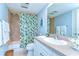Bathroom with toilet, sink, vanity and combined shower and bath with patterned curtain at 5019 Mill Pond Rd # 3128, Wesley Chapel, FL 33543