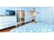 Light blue bedroom leading into a living room, bathroom, and closet at 5019 Mill Pond Rd # 3128, Wesley Chapel, FL 33543