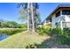 Exterior of a lakeside condo building with well-maintained landscaping and serene water views at 5019 Mill Pond Rd # 3128, Wesley Chapel, FL 33543