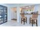 Open kitchen design with breakfast bar and seating, tile floor, and modern appliances at 5019 Mill Pond Rd # 3128, Wesley Chapel, FL 33543