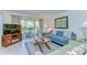 Comfortable living room featuring a TV, balcony access, and contemporary decor at 5019 Mill Pond Rd # 3128, Wesley Chapel, FL 33543