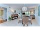 Open living area with dining, comfortable seating, and bright lighting with access to a balcony at 5019 Mill Pond Rd # 3128, Wesley Chapel, FL 33543