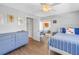 Bright bedroom with light blue walls, hardwood floors, ceiling fan, and ensuite access to the patio at 5208 Denver Ne St, St Petersburg, FL 33703