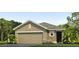 Charming single-story home featuring a neutral color scheme, a two-car garage, and well-maintained landscaping at 5519 Warrington Town Pass, Wesley Chapel, FL 33545