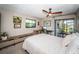 Bedroom features a ceiling fan and sliding glass doors leading to a screened patio at 575 Hickorynut Ave, Oldsmar, FL 34677